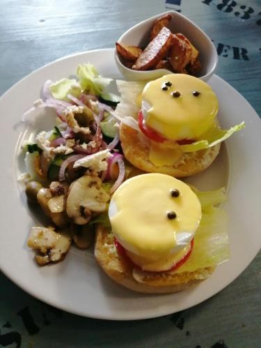 a plate of food with sandwiches and a salad at The Place Guesthouse Parys in Parys