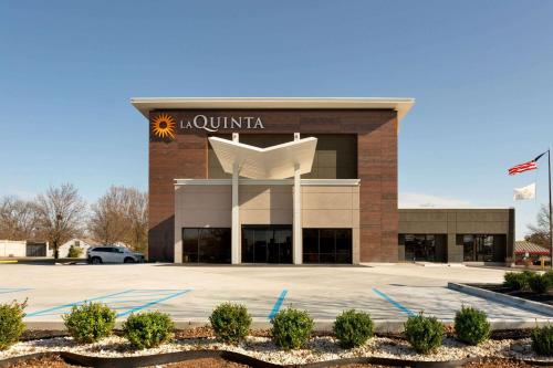a building with a sign on the front of it at La Quinta Inn & Suites by Wyndham St Louis Route 66 in Saint Louis