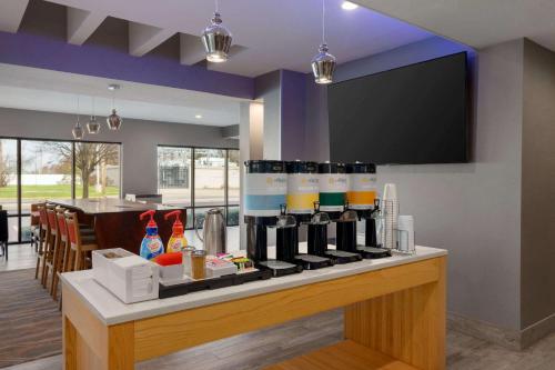 a bar with a bunch of bottles of wine at La Quinta Inn & Suites by Wyndham St Louis Route 66 in Saint Louis