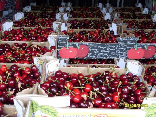 a display of cherries in boxes at a market at Casa Rural Amelia in Cepeda