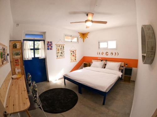 a bedroom with a bed and a ceiling fan at Odem Guest House in Odem