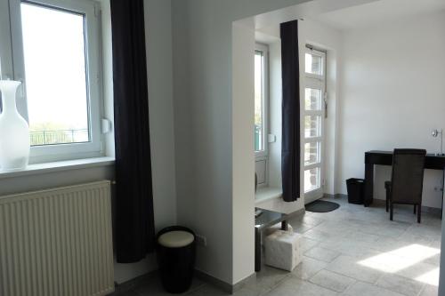 a room with a desk and two windows at Villa Luise in Hameln