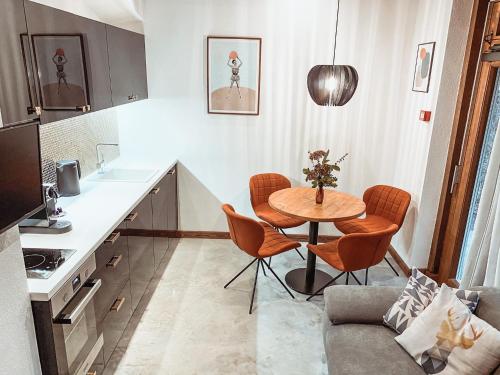 a small kitchen with a table and chairs in a room at Villa Gaida in Saulkrasti