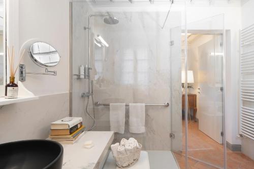 a bathroom with a shower with a glass door at Castello di Volpaia in Radda in Chianti