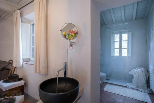 a bathroom with a black bath tub in a room at Castello di Volpaia in Radda in Chianti