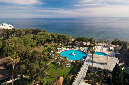 an aerial view of a resort with a pool and the ocean at Hotel Don Pepe Gran Meliá in Marbella