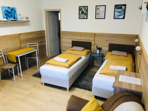 A bed or beds in a room at Melánia Vendégház