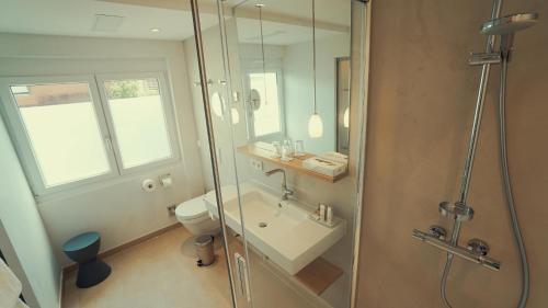 a bathroom with a shower and a sink and a toilet at Hotel Adler Asperg in Asperg