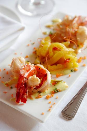 a white plate of food with shrimp and vegetables at Malabar House in Cochin