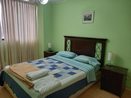 a bedroom with a bed with pillows on it at apartamento CAA pardo in Lima