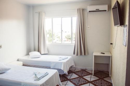 Postel nebo postele na pokoji v ubytování Hotel Colina