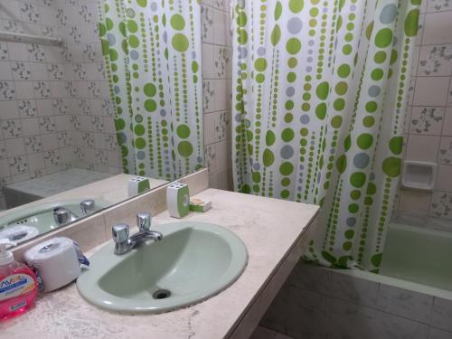 a bathroom with a sink and a shower curtain at apartamento CAA pardo in Lima