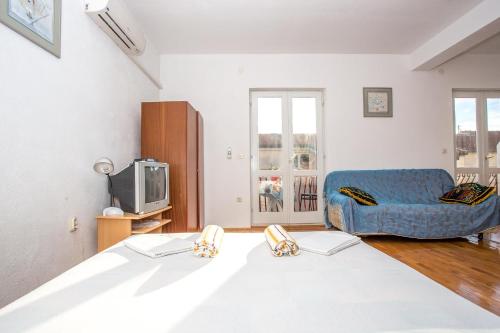 a bedroom with a bed and a blue couch at Apartments Nuic in Makarska