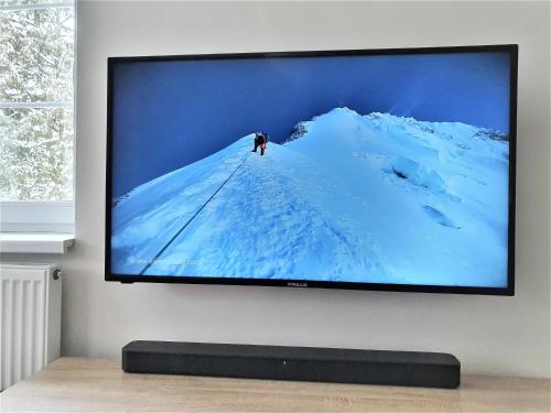 a flat screen tv hanging on a wall at Ubytování Javor in Pec pod Sněžkou