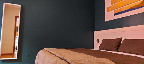 a bedroom with a bed and a blue wall at Casa Lady in Garda