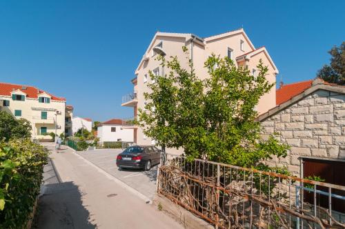 a car parked in a parking lot next to a building at Apartments Island Beat in Supetar
