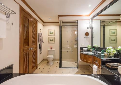 a bathroom with a tub and a shower and a toilet at JW Marriott Phuket Resort and Spa in Mai Khao Beach