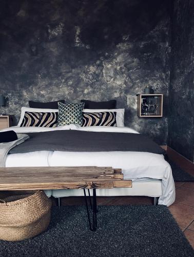 a bedroom with a large bed with a wooden table at A casa dalla Tata B&B in Meina