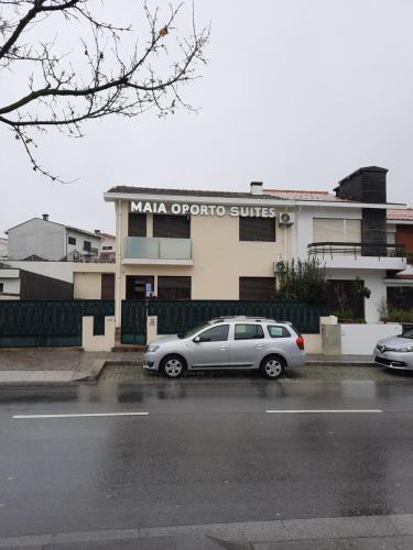 a car parked in a parking lot in front of a building at Maia Oporto Suites in Maia