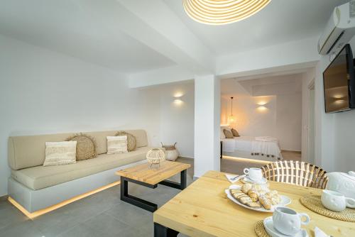 a living room with a couch and a table at Thealos Santorini in Pirgos