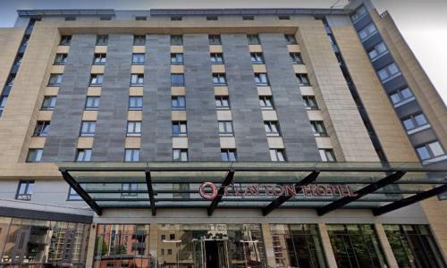 un edificio alto con un cartel delante en Clayton Hotel, Leeds, en Leeds