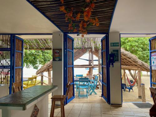 an open doorway to a patio with a table and chairs at Hostel Beach House in Rincón