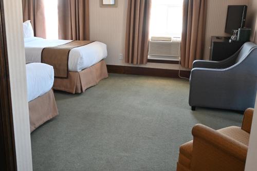 Ένα ή περισσότερα κρεβάτια σε δωμάτιο στο The Gananoque Inn