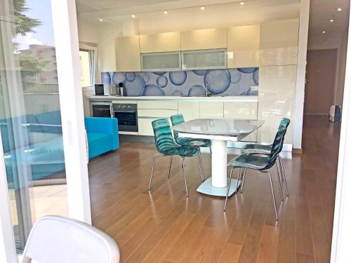 a kitchen with a table and chairs in a room at Roggia Apartments by Quokka 360 - a stone's throw from Ciani Park in Lugano