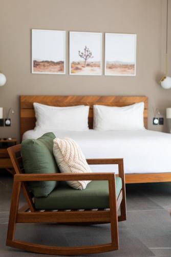 a bedroom with a large bed with a chair at San Trópico Boutique Hotel & Peaceful Escape in Puerto Vallarta