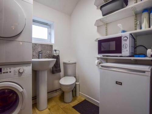 a small bathroom with a toilet and a sink at Granary, Cheltenham in Cheltenham