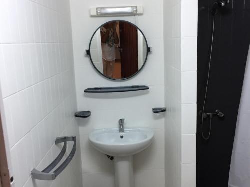 a bathroom with a sink and a mirror at Le Belleplaine in Le Gosier