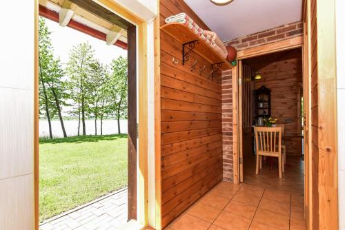 a wooden door leading to a patio with a table at Sodyba Pas Drambliuka in Svėdasai