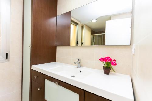 a bathroom with a sink and a mirror at Big Terrace Apartment Cullera in Cullera