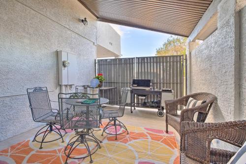 a patio with chairs and a table on a rug at 11 Mi to Dtwn Phoenix! Mtn-View Retreat with Hot Tub in Phoenix
