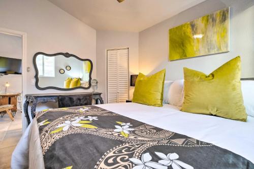 a bedroom with a bed with yellow pillows and a mirror at 11 Mi to Dtwn Phoenix! Mtn-View Retreat with Hot Tub in Phoenix