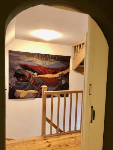 a hallway with a painting on the wall next to a staircase at Herberg Oud Holset in Lemiers