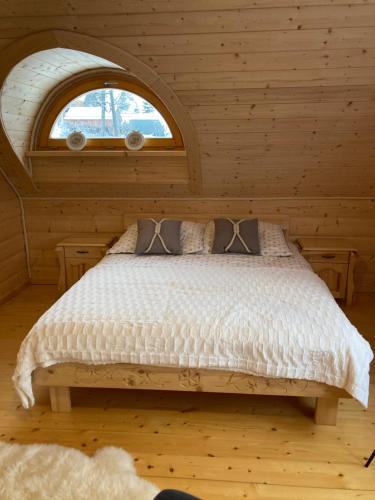 a bedroom with a bed in a log cabin at Chata Nad Potokiem w Górach in Kamesznica