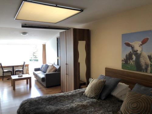 a bedroom with a bed and a living room at Herberg Oud Holset in Lemiers