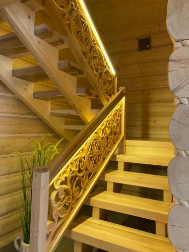 a wooden staircase with a yellow stair railing at Chata Nad Potokiem w Górach in Kamesznica