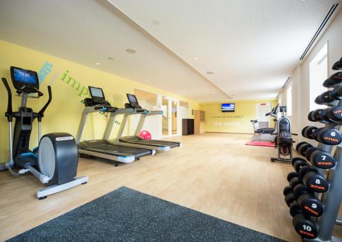 a gym with treadmills and exercise equipment in a room at Holiday Inn Resort Shinano-Omachi Kuroyon by IHG in Omachi
