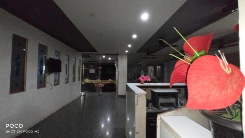 a living room with a red flower on the floor at Hotel Jaidharshini Palace in Kumbakonam