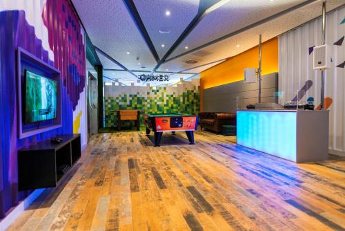 a gaming room with a pool table and a tv at Spring Hotel Bitácora in Playa de las Americas