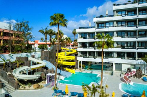 a resort with a pool and a water slide at Spring Hotel Bitácora in Playa de las Americas