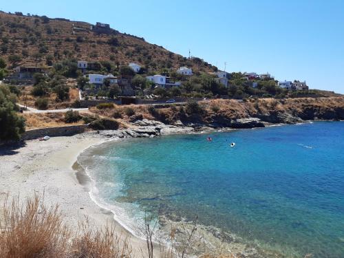 a beach with people swimming in the water at Villa Ligia Beach in Koundouros