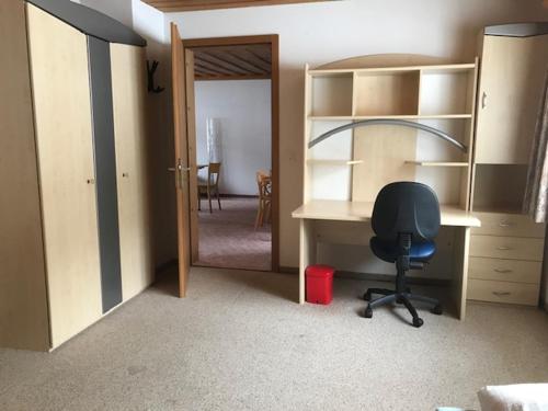 an office with a desk and a chair in a room at Hotel Alpina in Unterwasser
