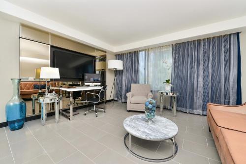 a living room with a couch and a table at voco Laguna Hills by IHG in Laguna Hills
