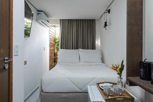Säng eller sängar i ett rum på Casa Villa Noronha Suites