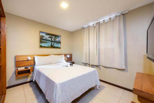 Una cama o camas en una habitación de Pousada Bahia 10