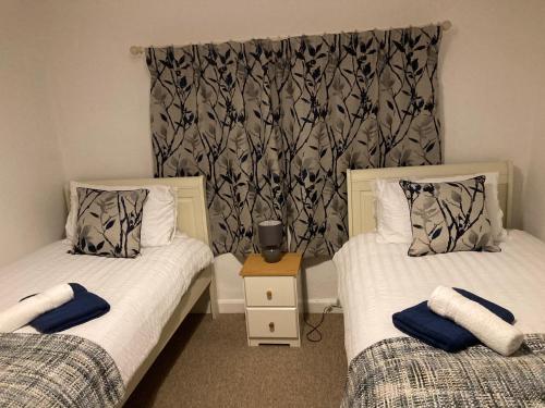 Кровать или кровати в номере Holcot Cottage