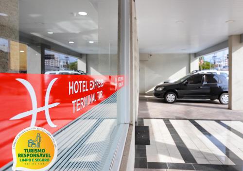 a reflection of a car in a store window at Hotel Express Terminal Tur - Rodoviária Porto Alegre in Porto Alegre